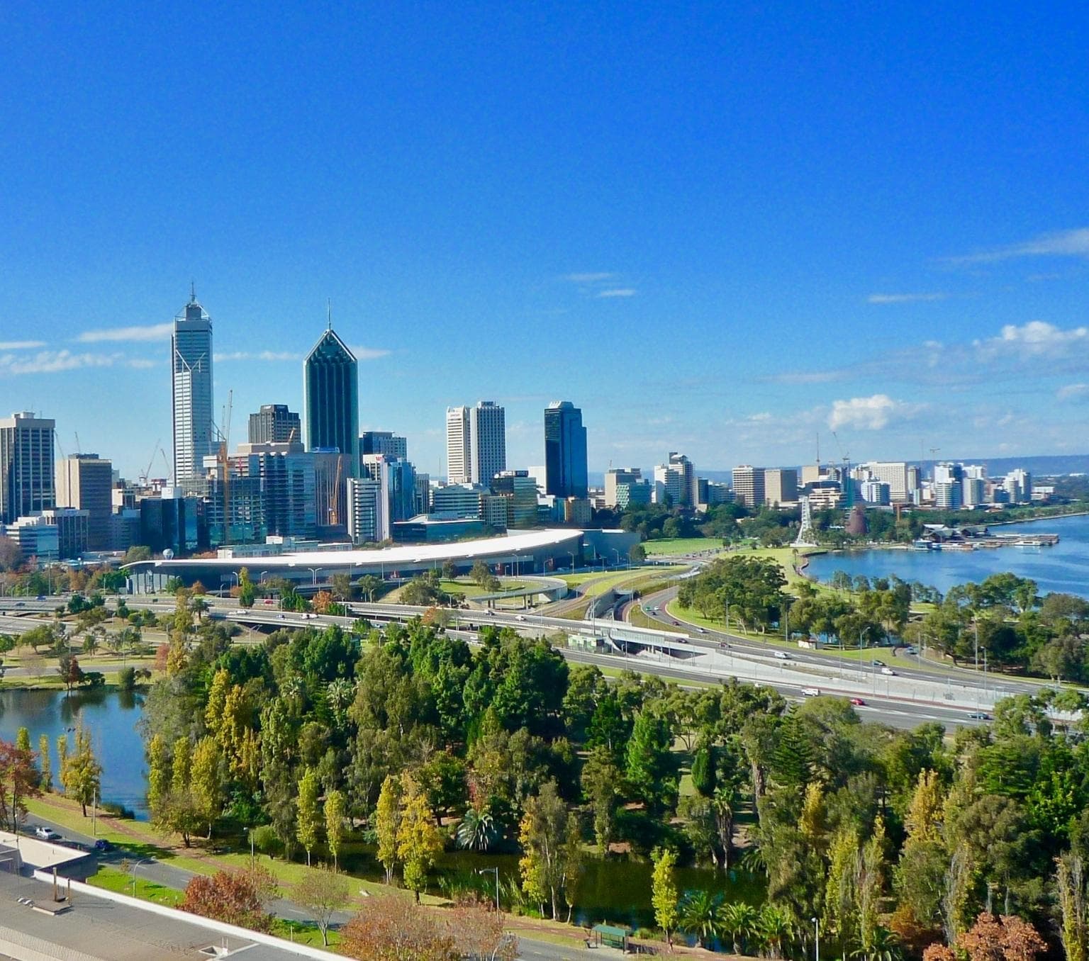 view of Perth City with sky scrapers, highways and a lake