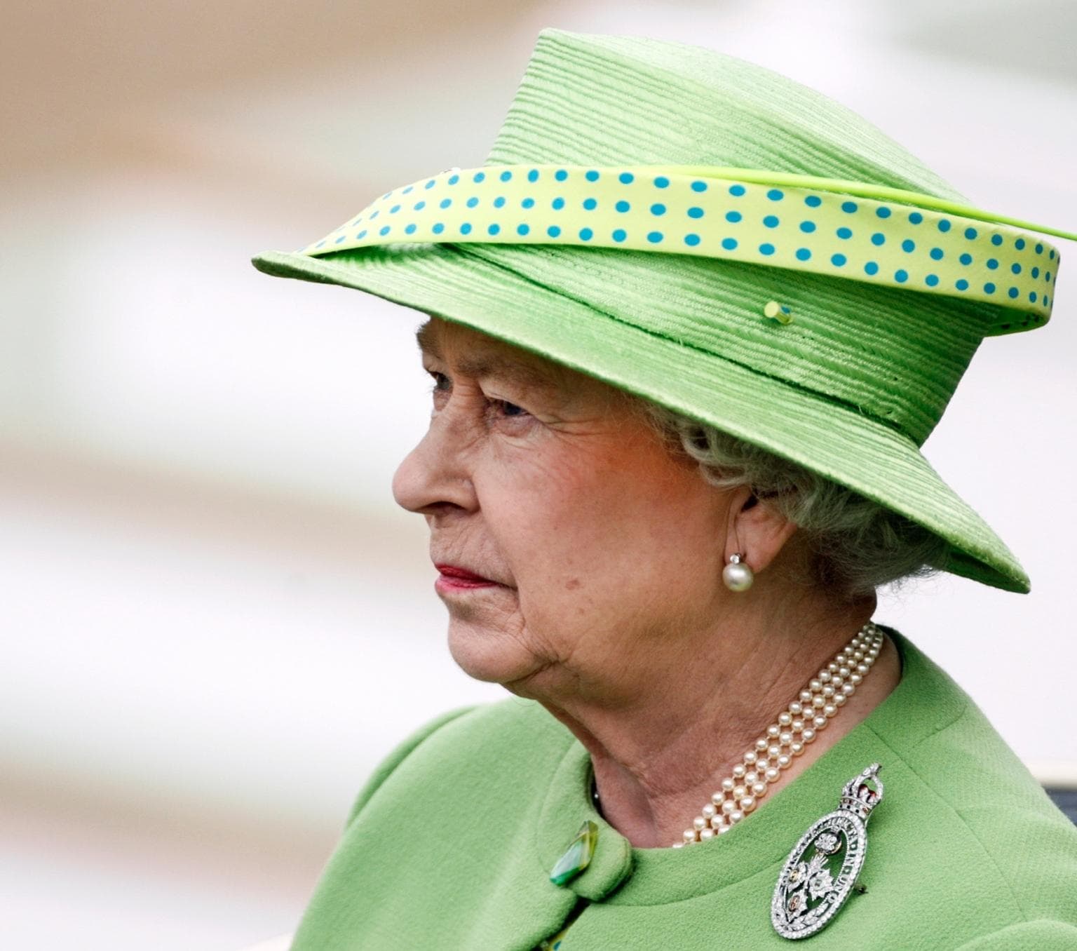 Queen Elizabeth wearing a green hat and coat.