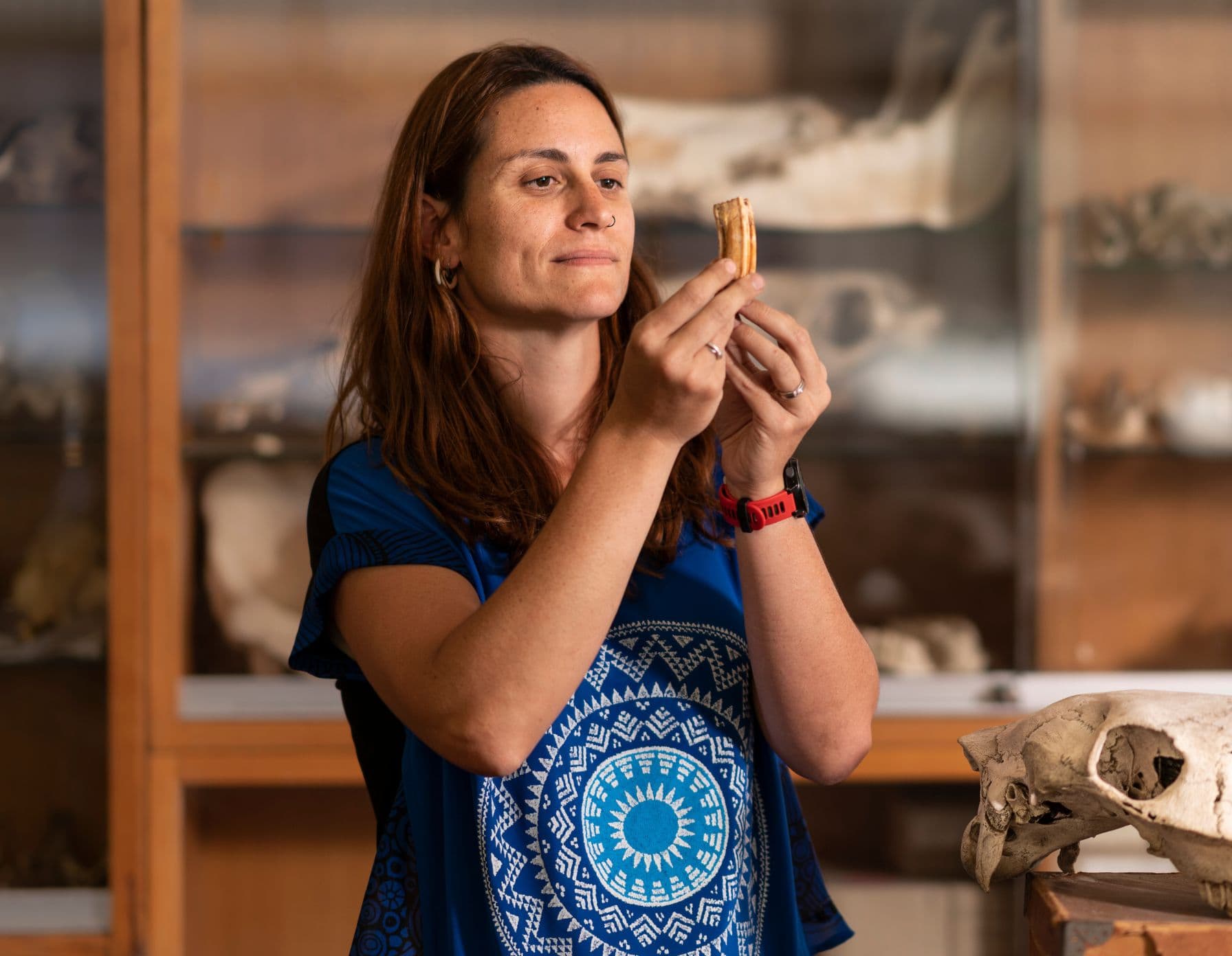 A female scientist examining a remain.