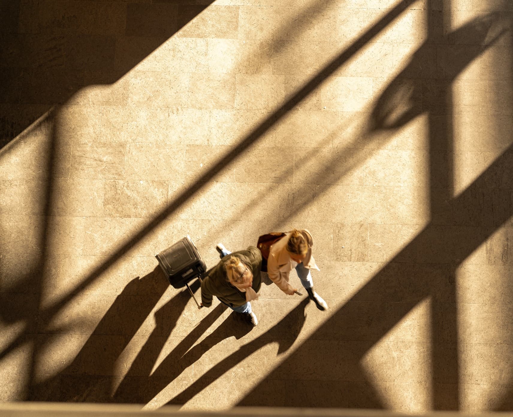 Aerial view of a person walking with a suitcase