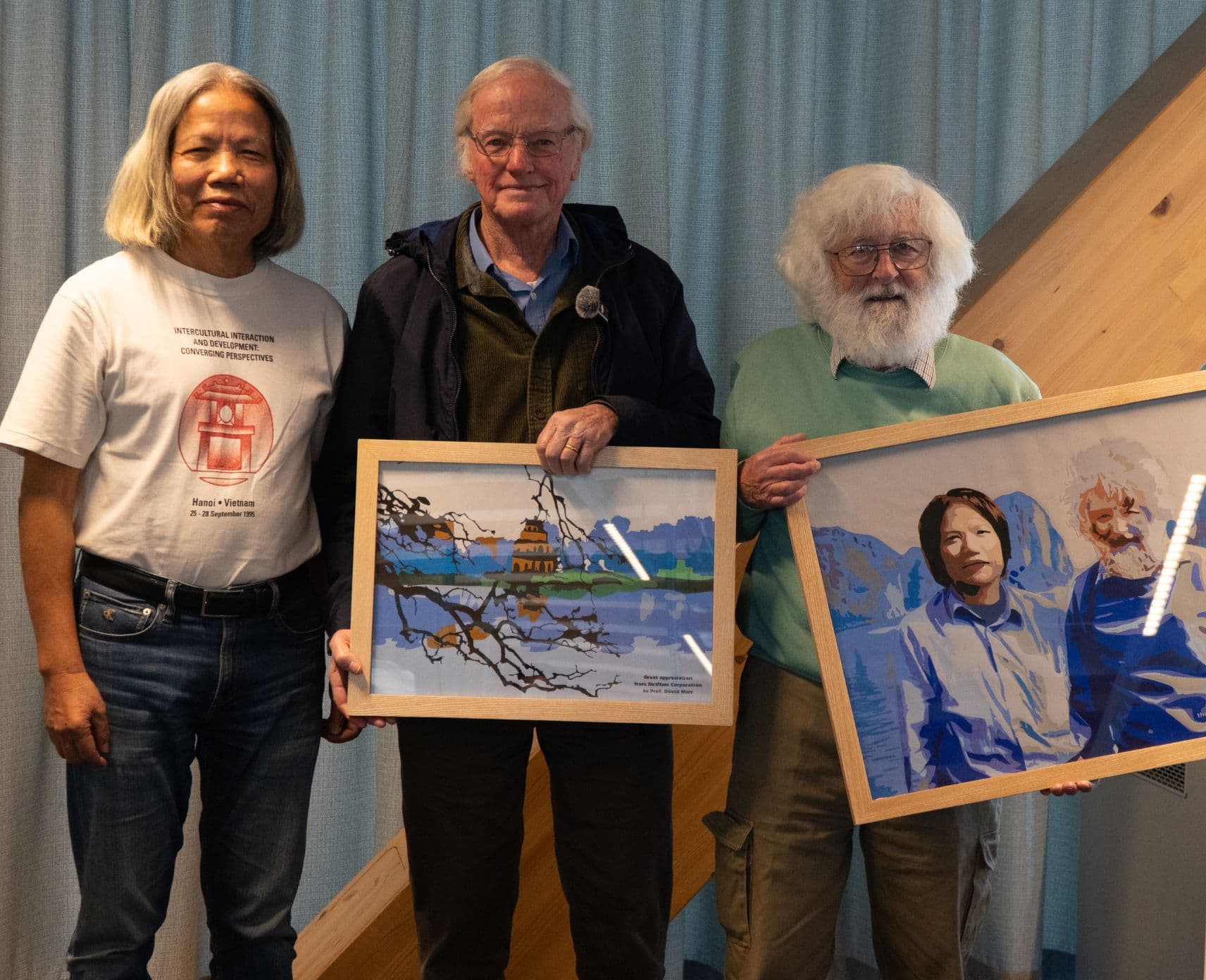 Netnam Chairman Trần Bá Thái with Dr Rob Hurle and Emeritus Professor David G Mar hold gifted paintings