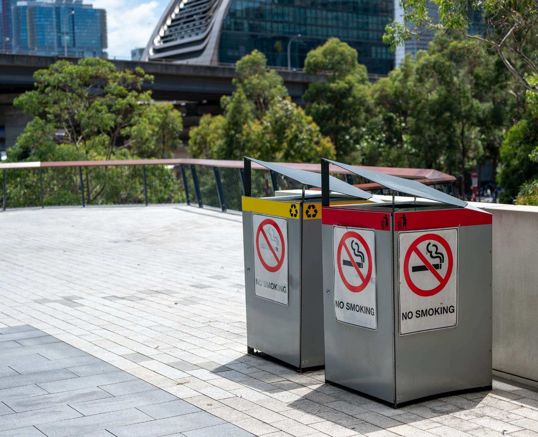 A photo of two public rubbish bins, both with no smoking signs.