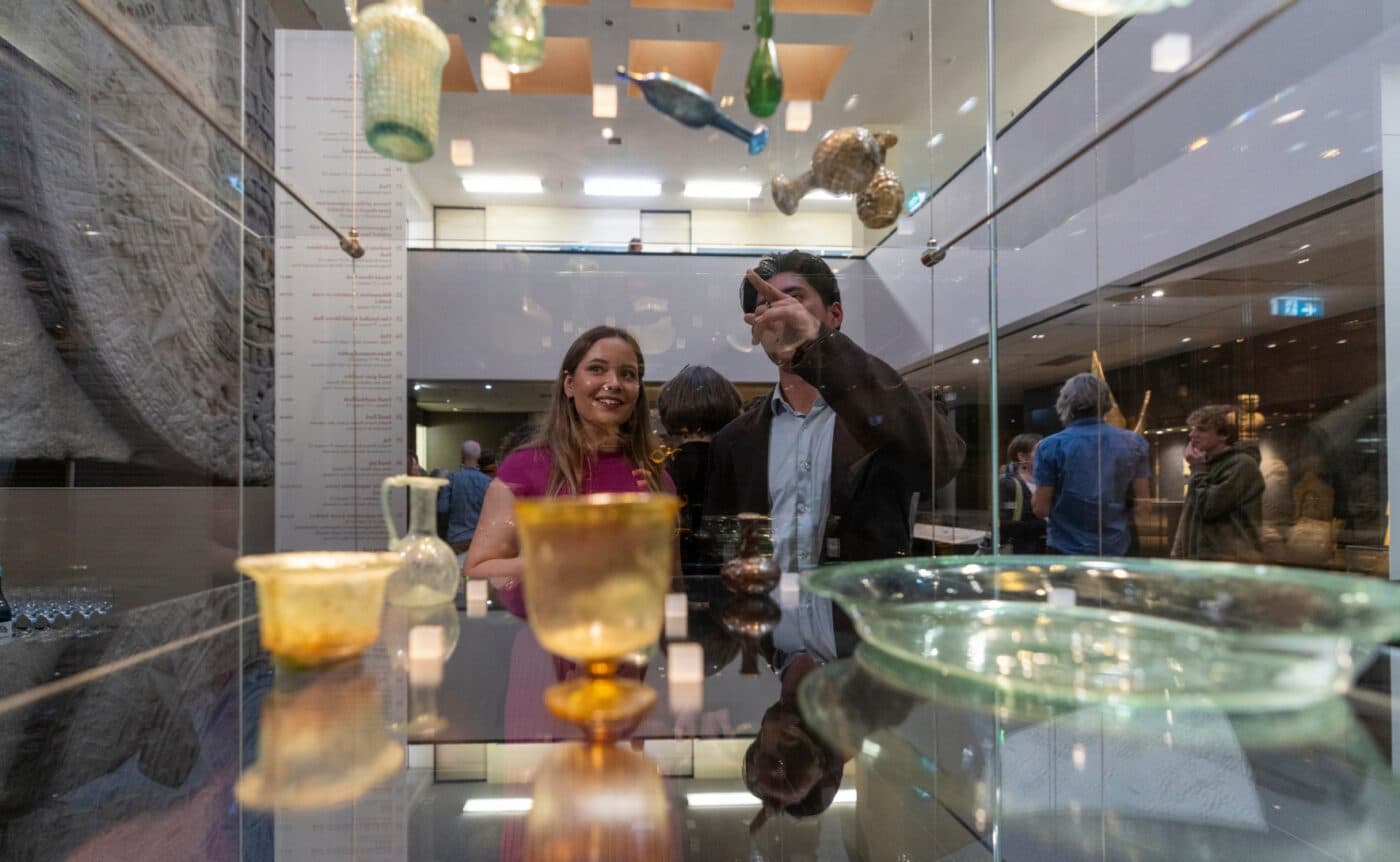 Two people look at a display of hanging glassware