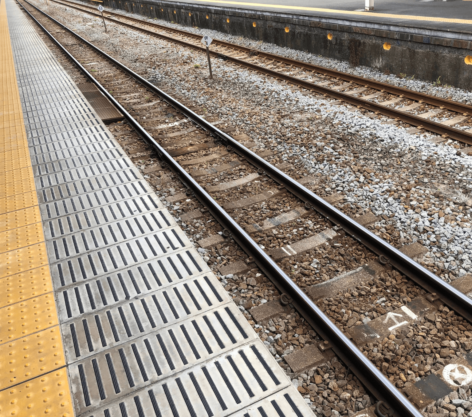 Empty train platform and railway tracks.