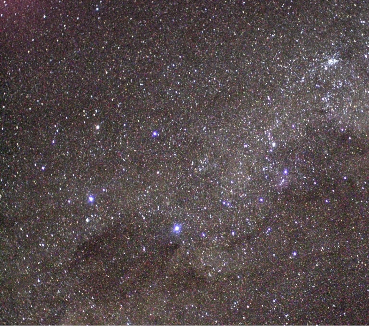 The Southern Cross (left center), the Coal Sack Nebula (bottom left), and the Carina Nebula (upper right) are visible in this view