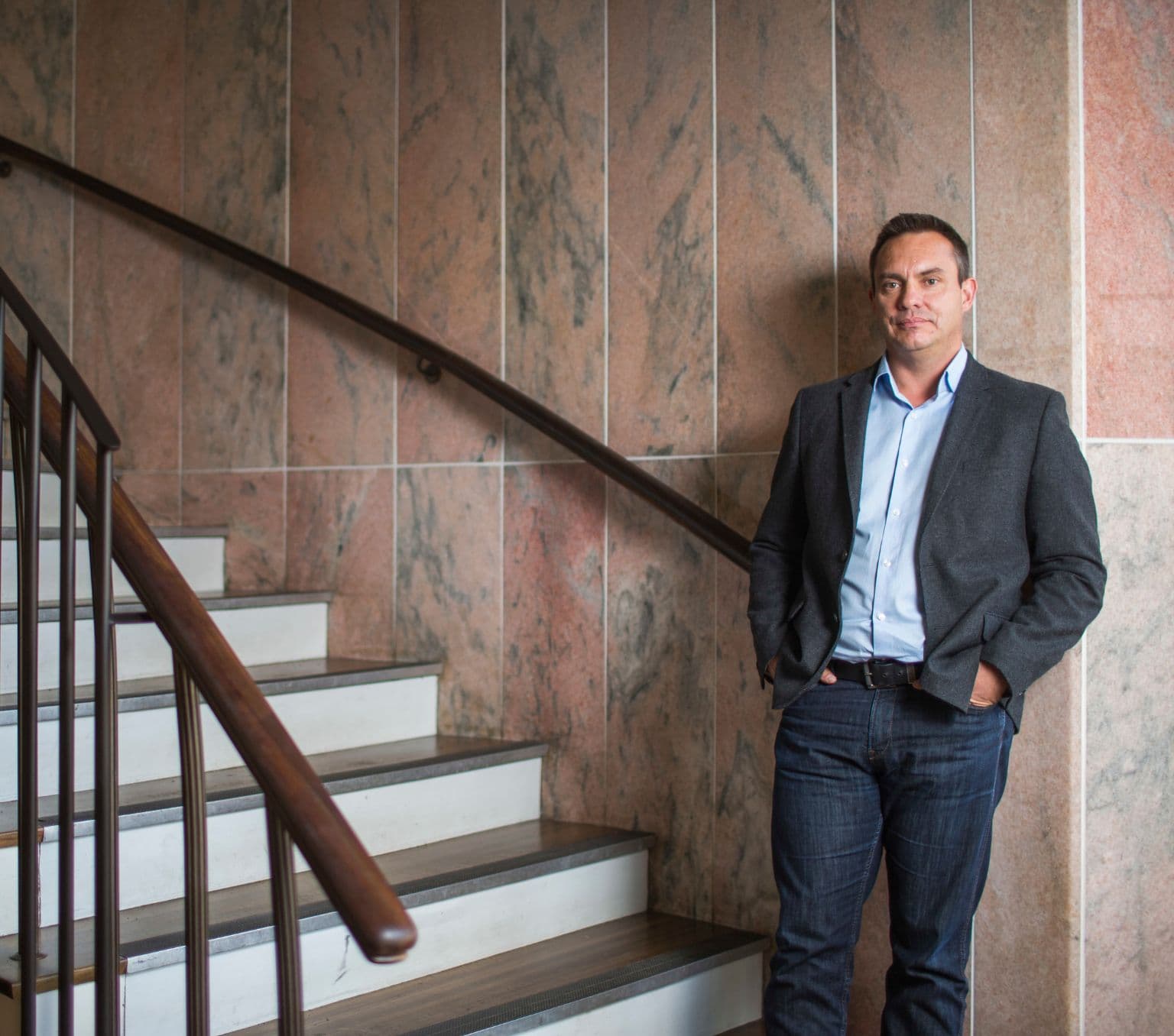 Professor Ray Lovett standing at the bottom of a staircase
