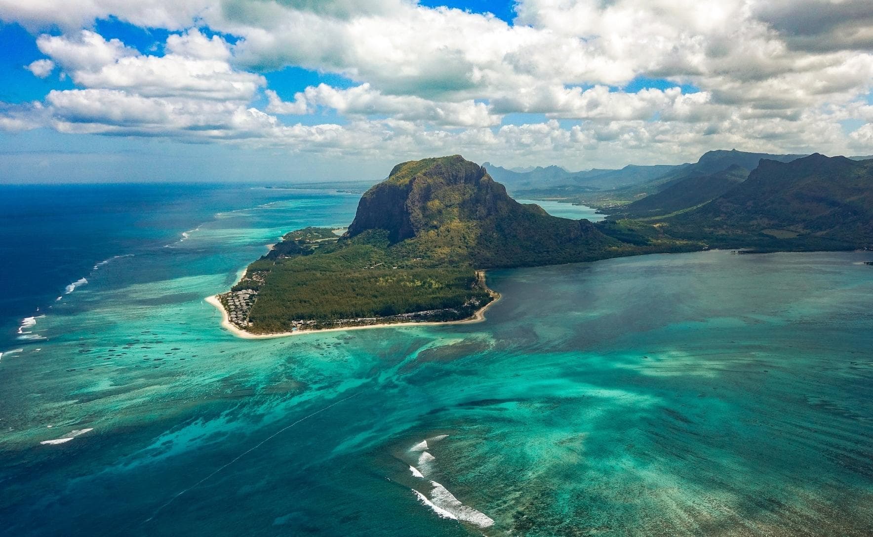 Aerial view of an island surrounded by clear aqua water