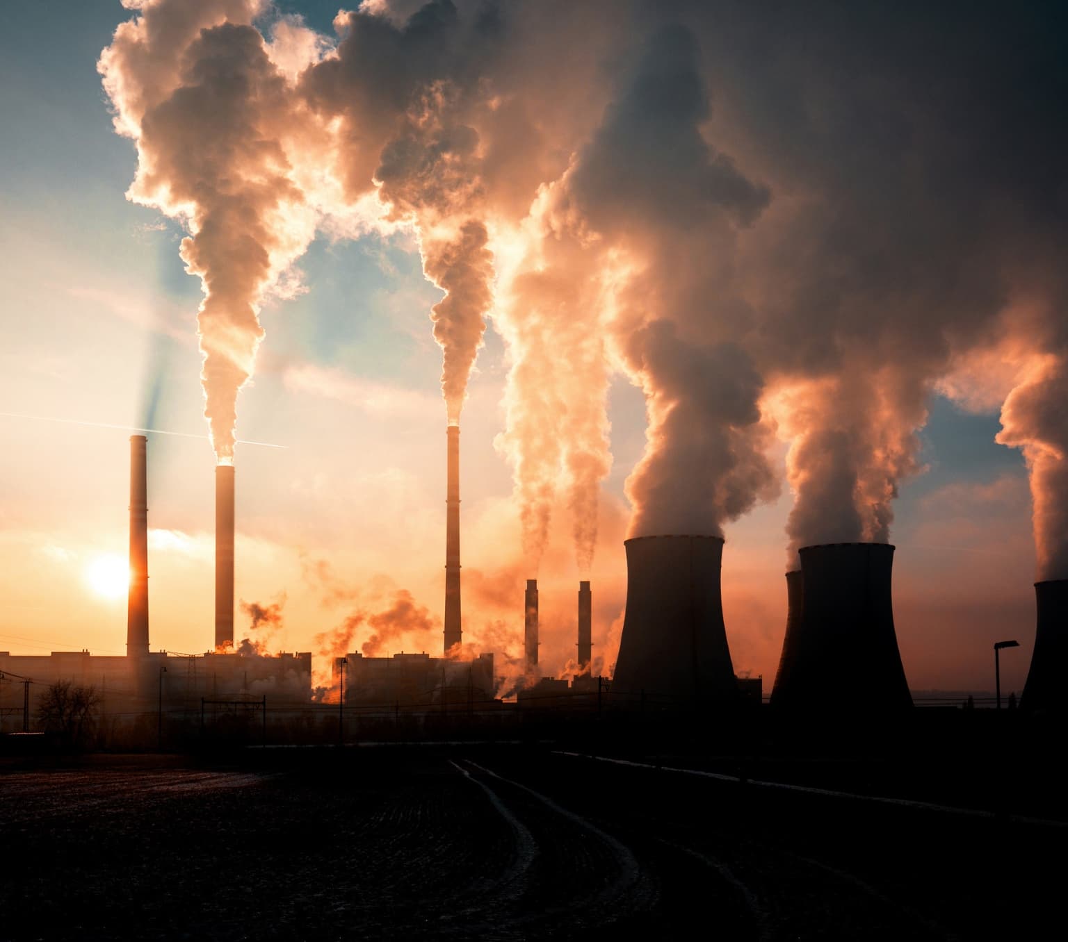A coal fired power station silhouette at sunset
