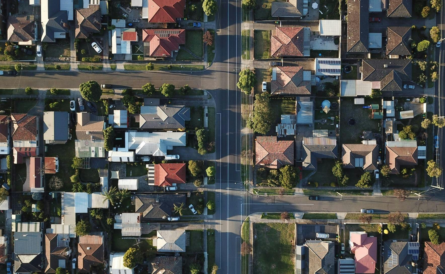 Aerial view of a suburban area with houses and streets.