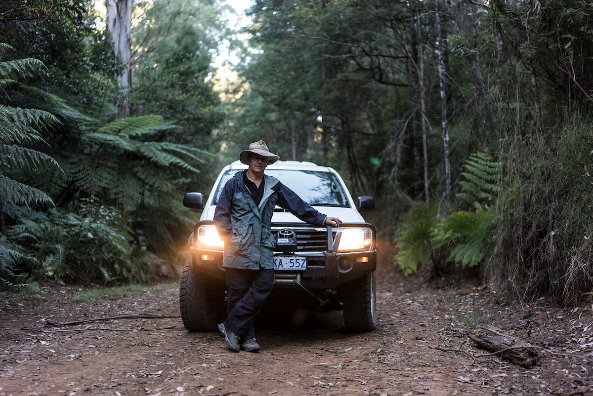 David Lindenmayer stands in front of a car i n the Victorian forrest.