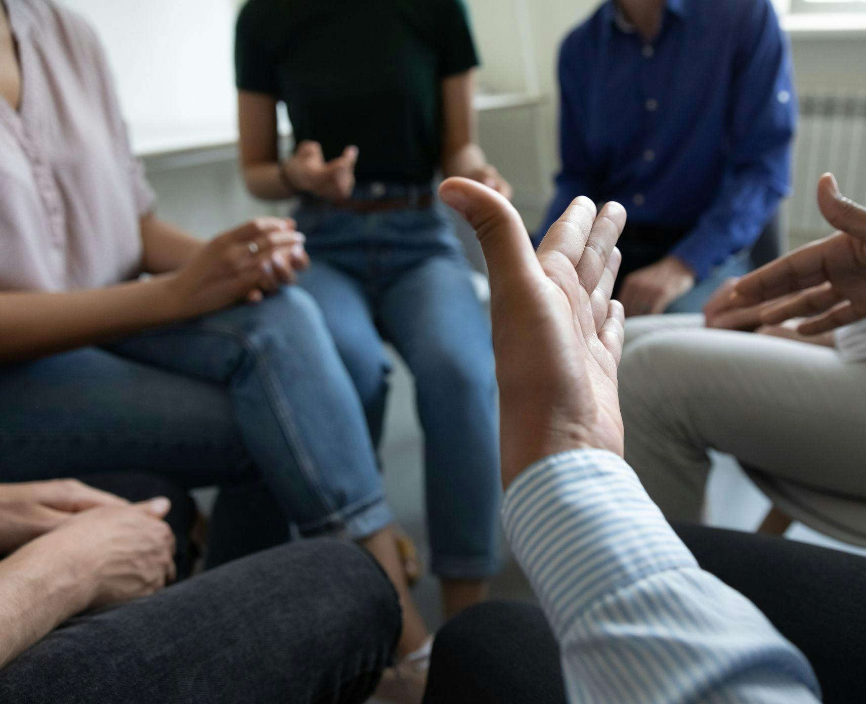 An image of people's hands at a meeting