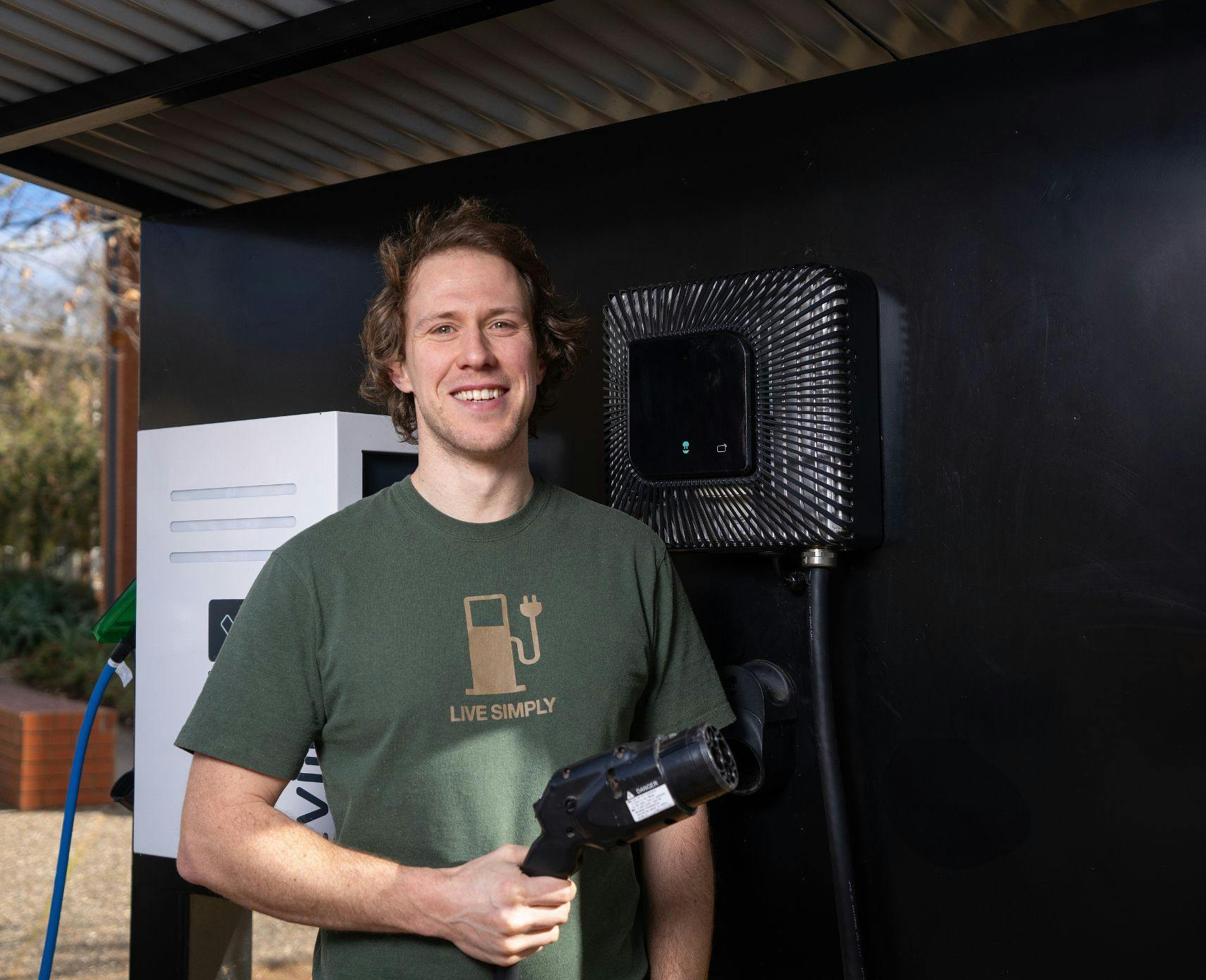 Bjorn in front of an electric car charge station. He has recently been awarded ACT Scientist of the Year