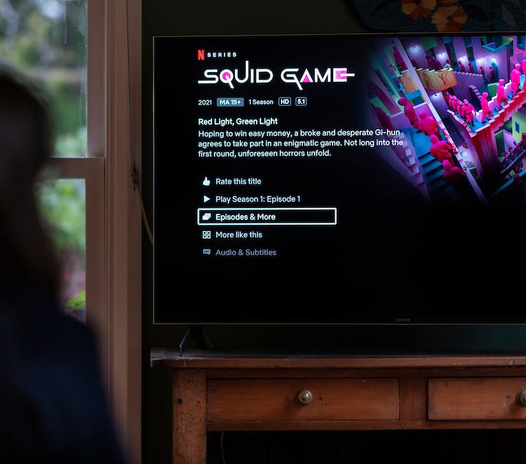 Person watching Squid Game on television.