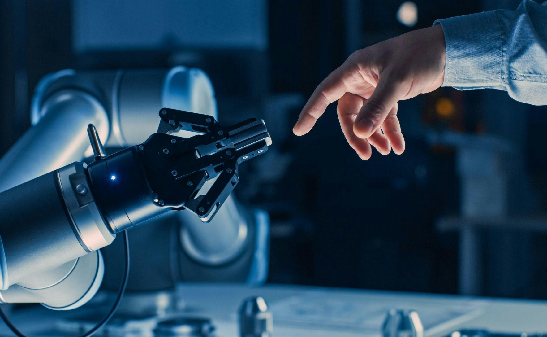 Human hand touching a robot hand